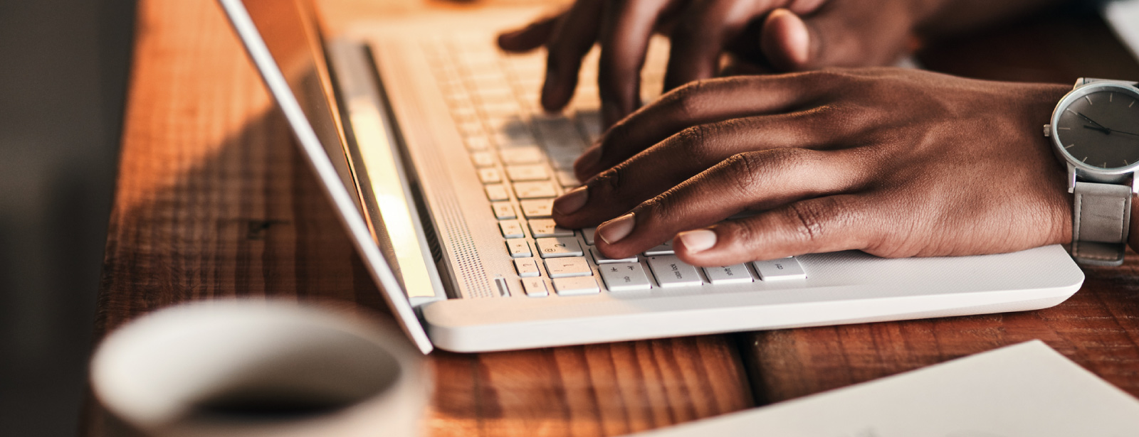 Picture of someone typing on a laptop keyboard.